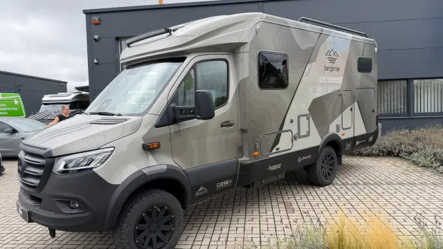 Bergbrise-Wohnmobil mit Folierung in Grau- und Sandtönen und Höhenlinien-Design – Frontansicht